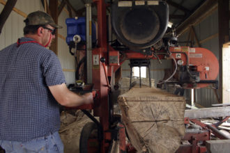 Sawyer Charles Fugate works at ASD's Sustainable Woods processing mill, a 3.5 acre facility that includes a log yard, sawmill, two dry kilns, a millworks manufacturing facility and storage. Sawyer Charles Fugate working at 3.5 acre facility that includes a log yard, sawmill, two dry kilns, a millworks manufacturing facility and storage.