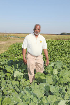 Leslie Glover standing in a field.