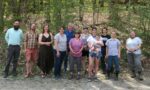 Northeast SARE Staff standing in a line facing the camera. There are trees behind them