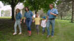 Luke peterson and family walking holding hands outisde.