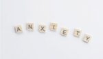 Scrabble tiles spelling out the word ANXIETY