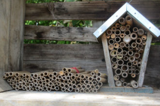 Bee houses Bee houses with rolled stacks on the side and in the house