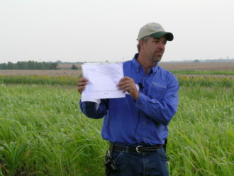 Brian Berns holding a data chart during a field day. Brian Berns holding a data chart during a field day.