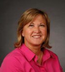 woman with pink shirt, blonde hair