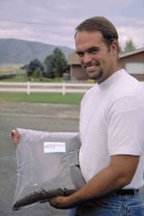Photo B. Utah egg producer Mike Shepherd holds composted poultry manure.
