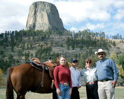 Driskill Family next to a horse and a hill in the background