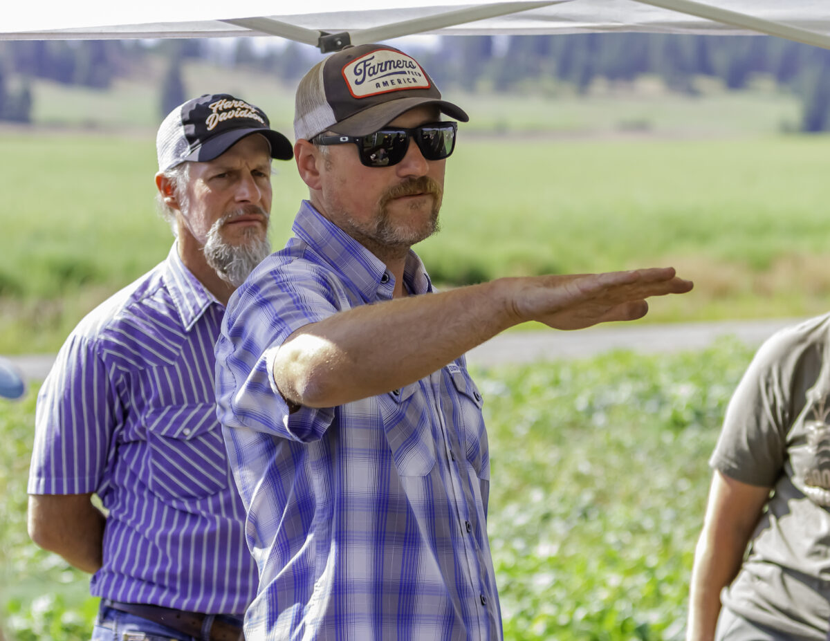 Farmer explaining something with his hand outstretched