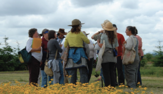 A group of people standing in a circle outside