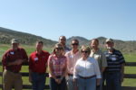SARE Fellows standing in front of a fence of pastures and mountains in the background