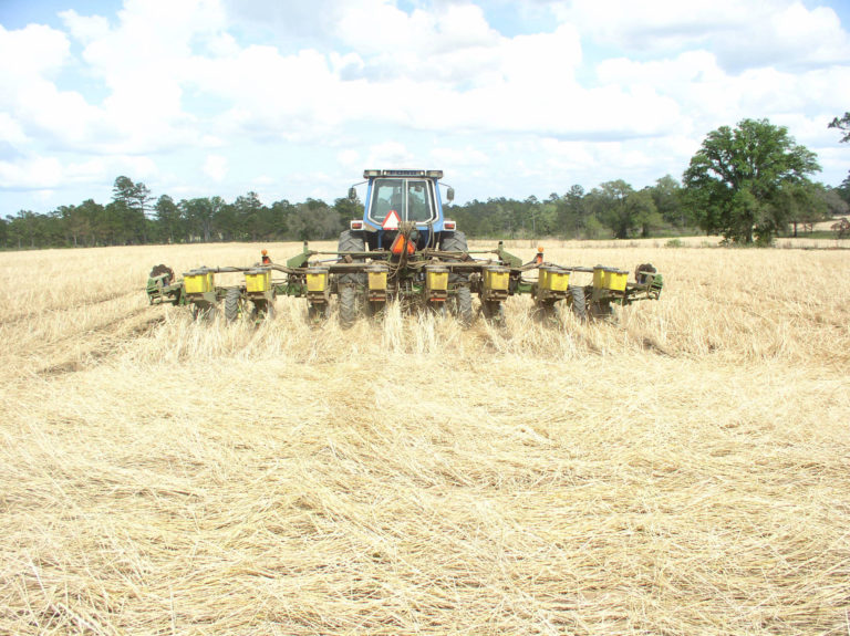 Figure 18.3 A wide attachment to the tractor in a tan field