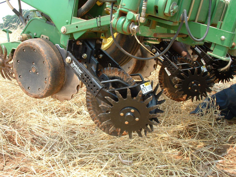Figure 9.10 A tractor with a wheel with spikes coming from it attached to the tractor