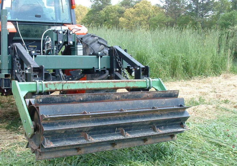A ribbed roller attachment to a tractor