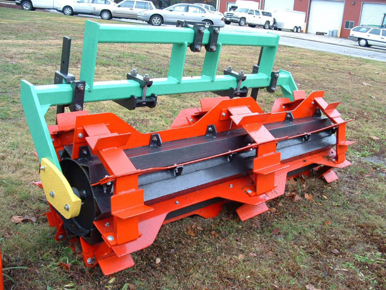 A red rolling attachment for the tractor
