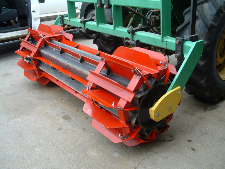 A red rolling attachment for the tractor