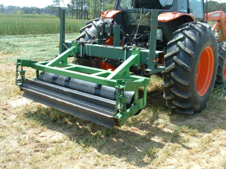 Tractor with a green attachment shaped like a roller