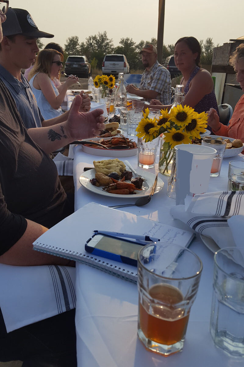 People talking business at the table during an on-farm dinner event