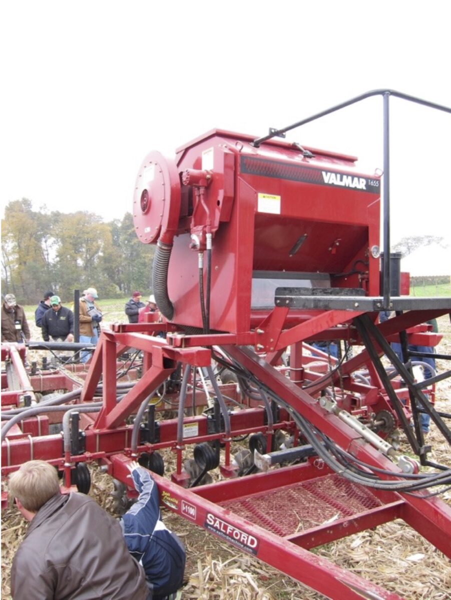 people are examining how the tillage tool was modified for seeding