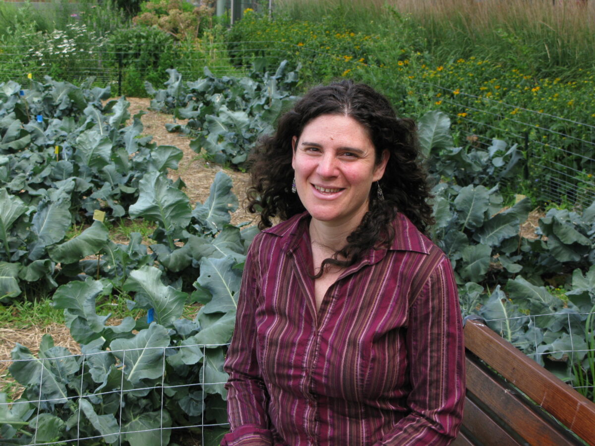 Headshot of Shoshanah Inwood outside in a field
