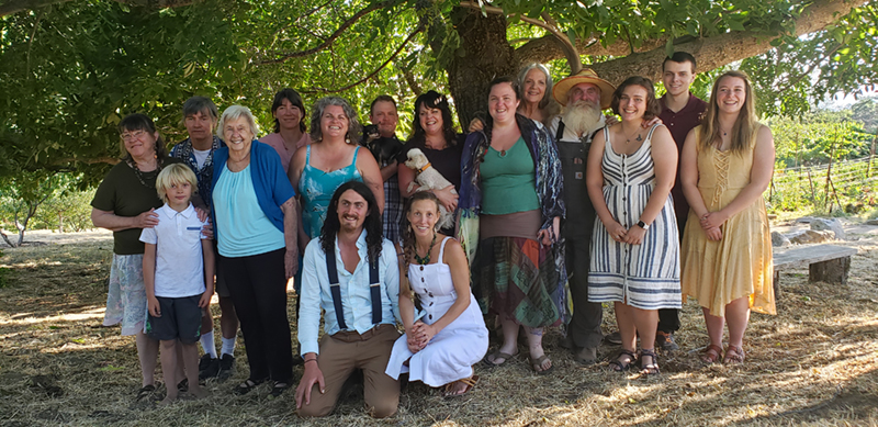 A large extended family posing for a photo at their farm