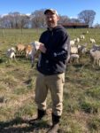 Farmer Lee Holcomb holding a lamb.