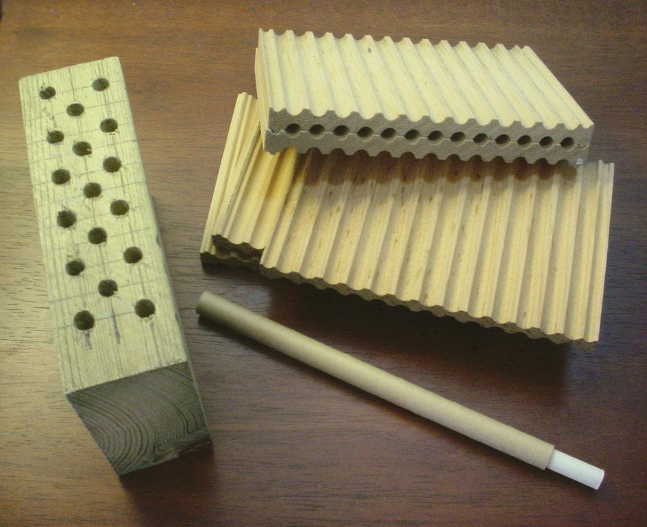 Nest options including drilled wooden blocks, grooved boards, and cardboard tubes.