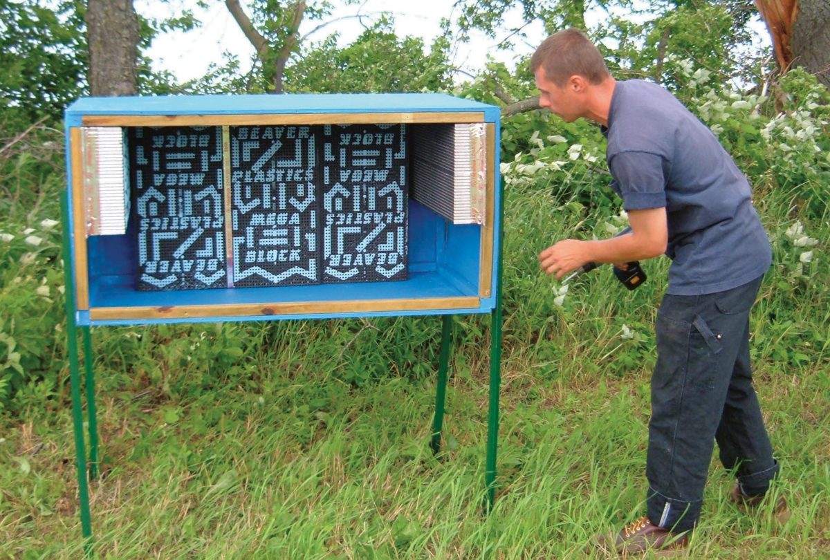 The author, Eric Mader, installing a leafcutter bee shelter.