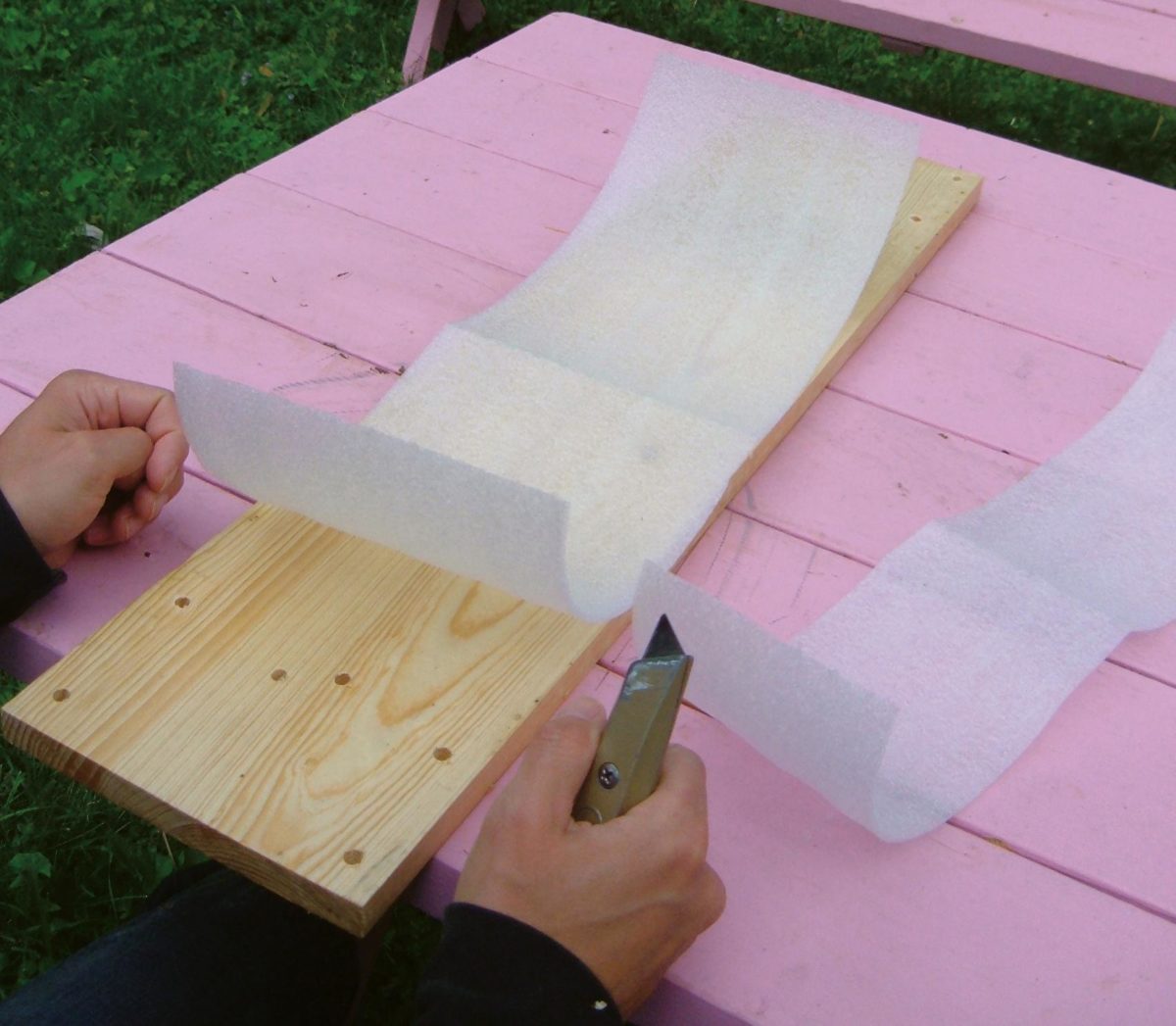 Backing material (closed-cell packing foam) being cut.
