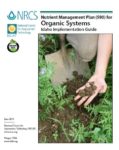 Cover of an article about organic systems featuring a hand in the soil