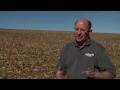 Ray Gaesser in a field explaining something