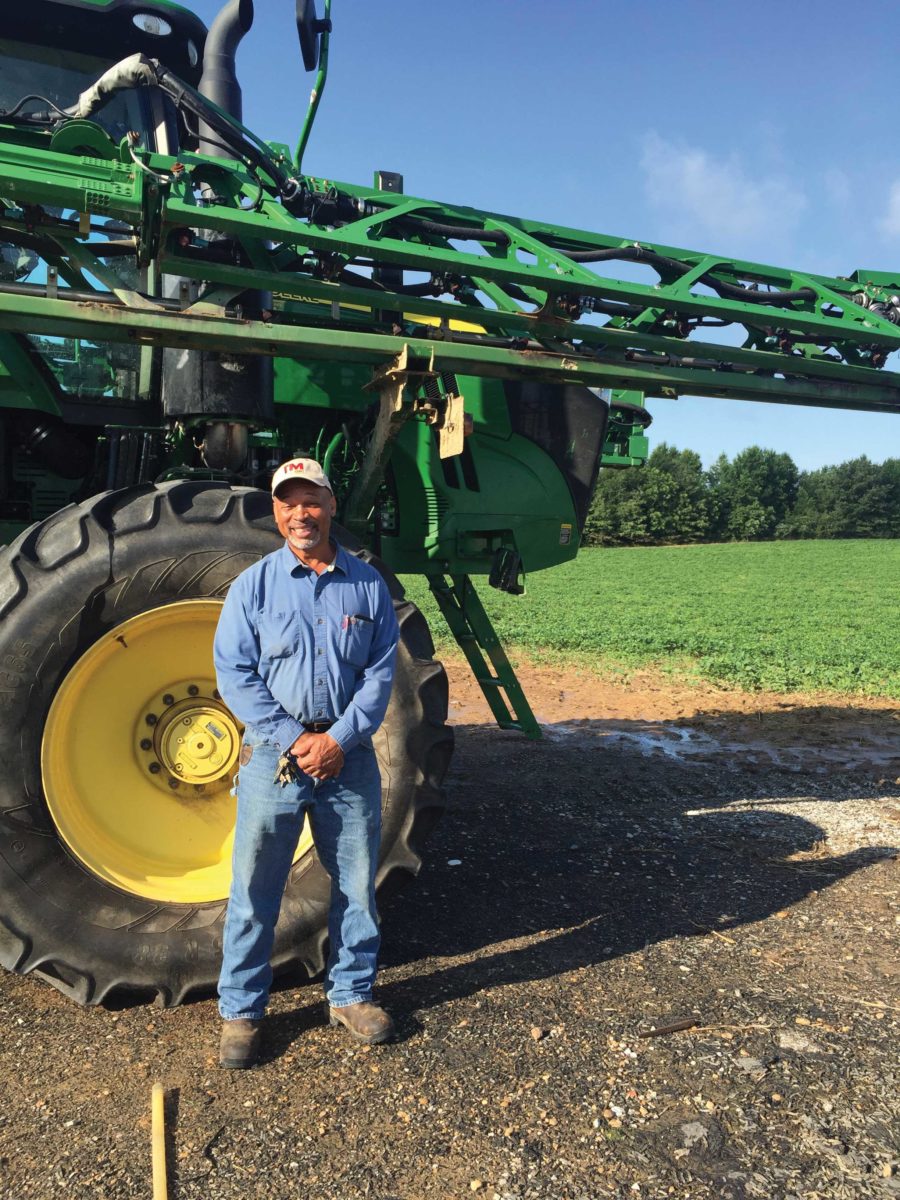 Farmer posing in front of a tractor Farmer posing in front of a tractor