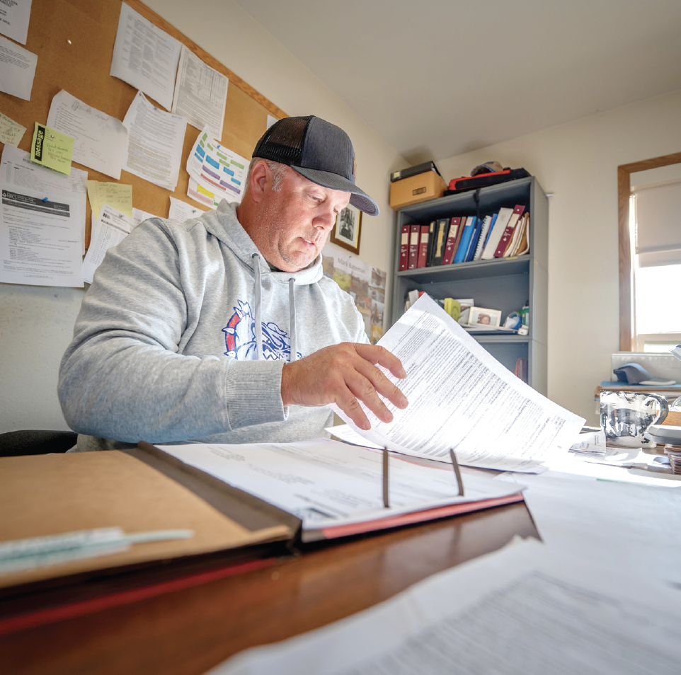 Man looking through papers at a desk