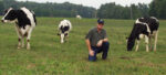 Farmer Tom Trantham with dairy cows in a field