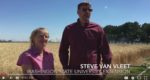 Training Ag Professionals in IPM video screenshot showing two farmers standing together in front of a wheat field