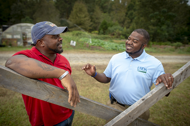 USDA specialist talking with farmer