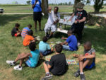 Children play pollinator bingo game
