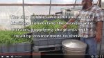 Video Screenshot of text explaining aquaponics with a man pointing to crops in a bin