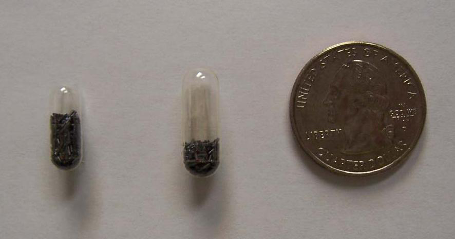 Two pills side by side with different amounts of COWP in each, compared to the size of a quarter.