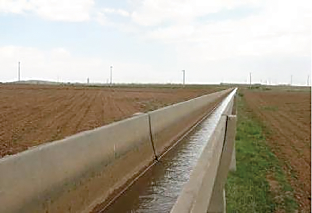 harran plain with water in a long man made passage along a field