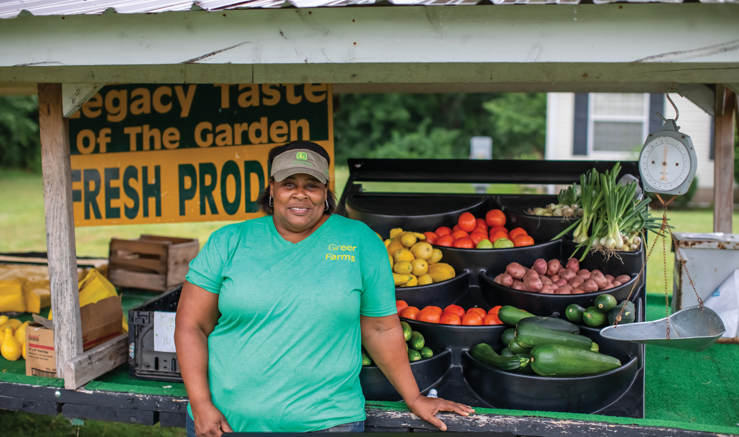 A woman in front of a produce stand