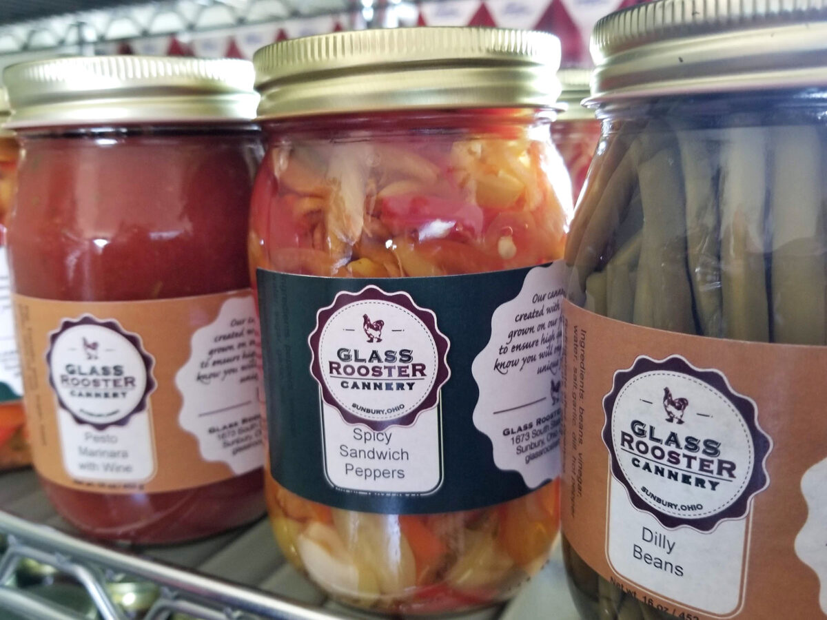 Close up of pickled vegetables in glass jars. 