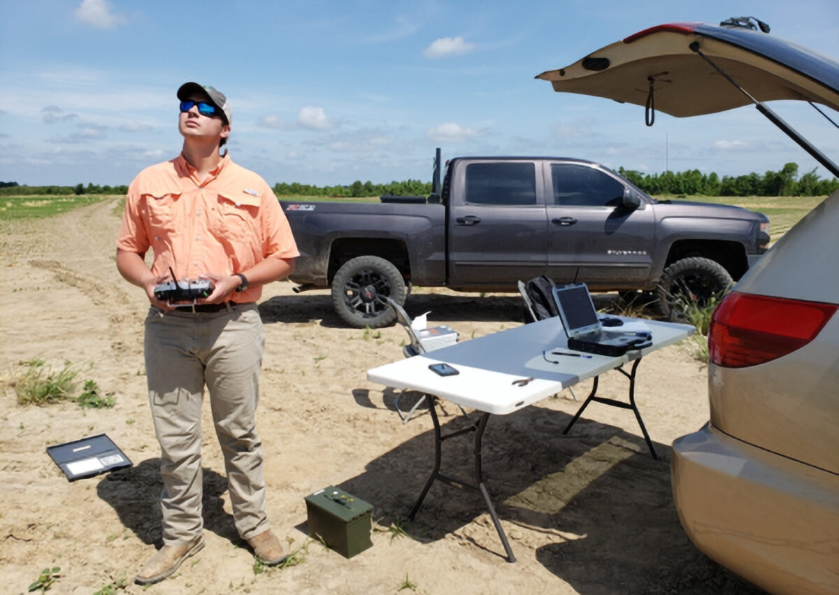 Person looking up at drone