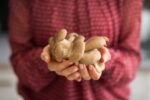 woman holding oyster mushrooms