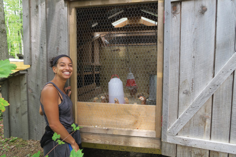 Leah Penniman A woman smiling outside of a chicken coop