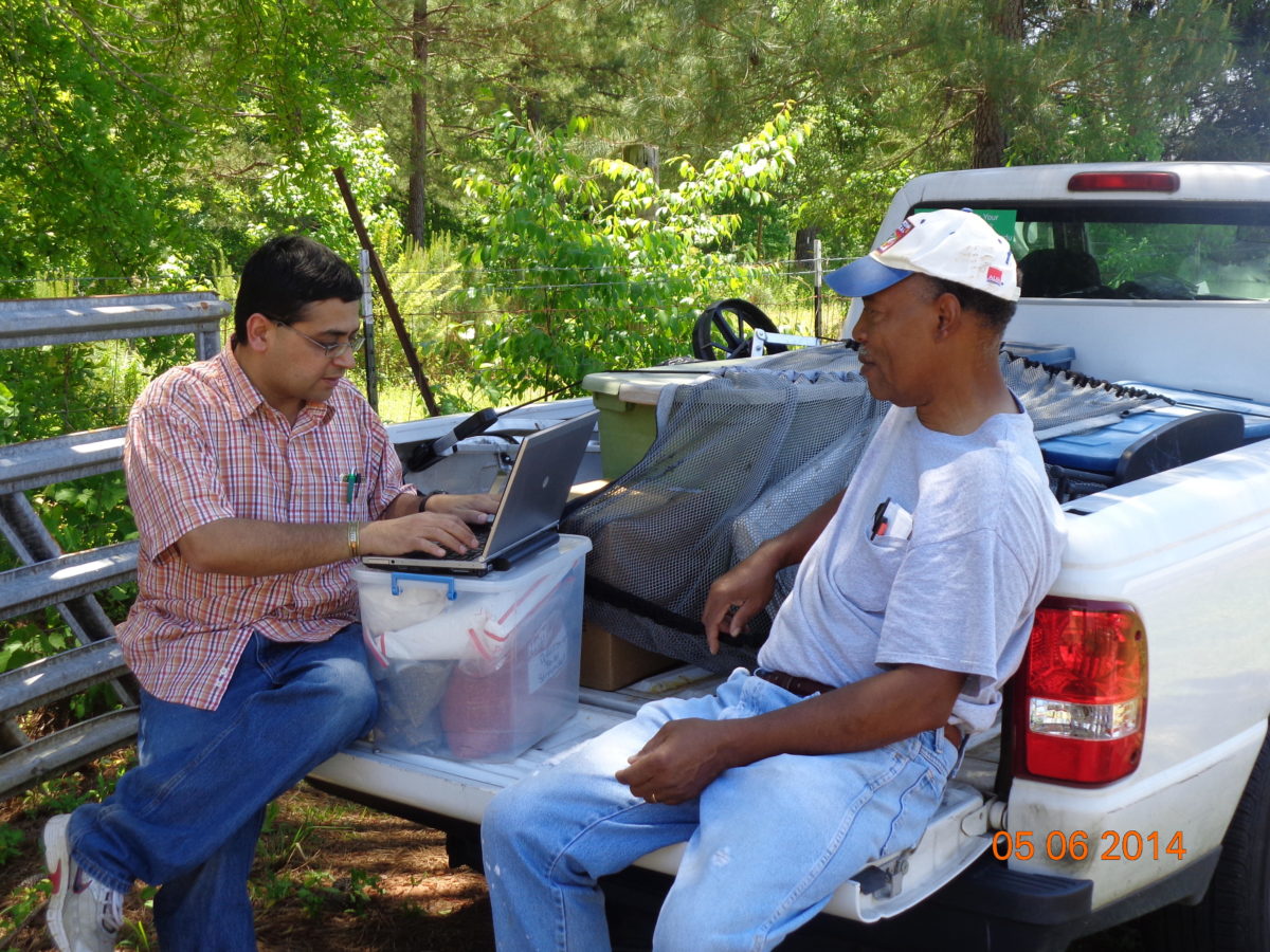 Two men in back of pickup truck
