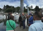 People standing around a pier talking