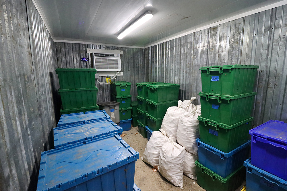 A storage shed with LED lights and an air conditioning unit in the wall.
