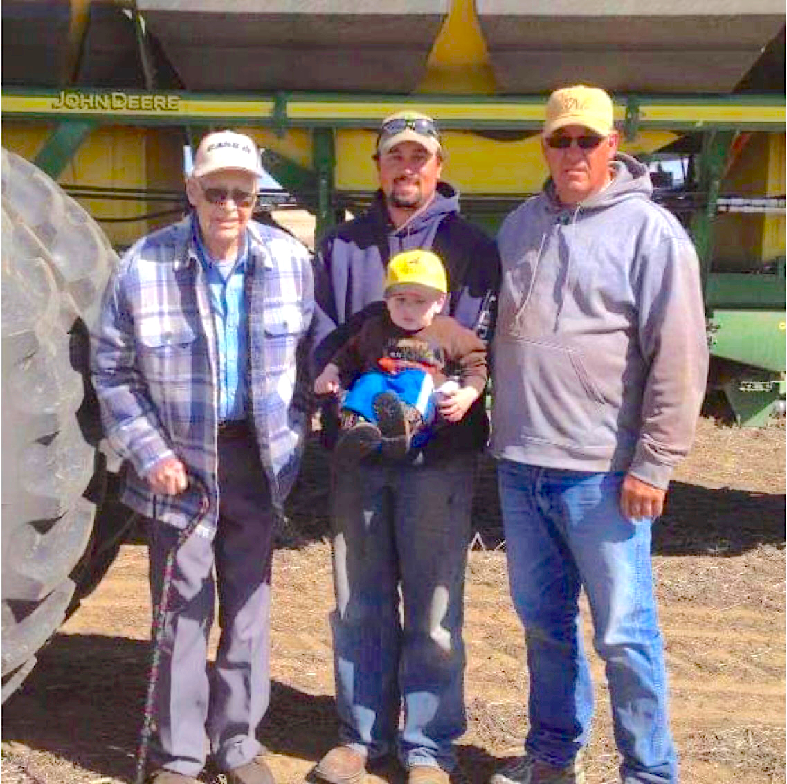 A portrait of four generations of the Wasson family, including a great grandfather, a grandfather, a father and a baby.