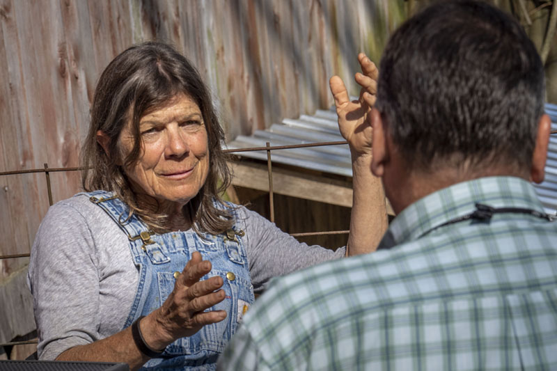 A woman speaking to another person