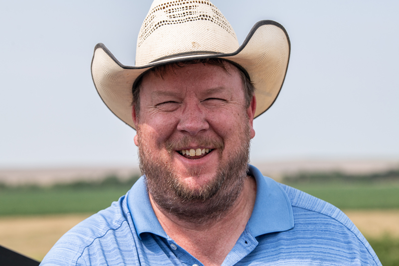 Portrait of a young white man in his farm field