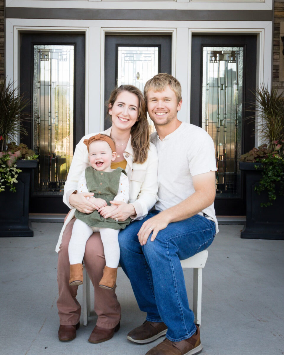 A portrait of Justin and Molly Zahradka with their baby daughter.